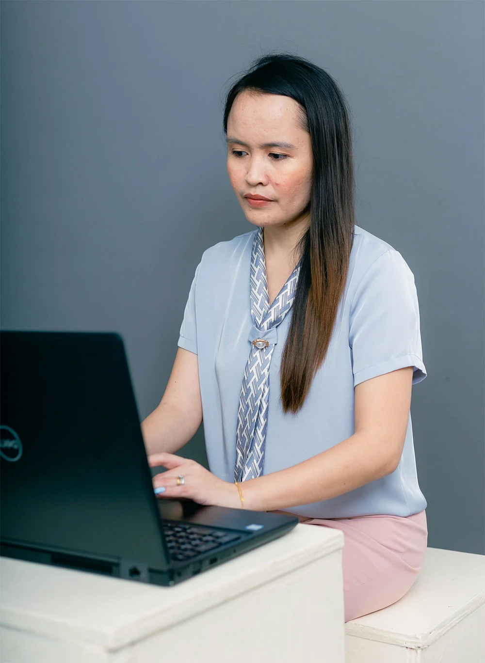 Shara Idnay, a Filipino SEO specialist is sitting in front of her laptop